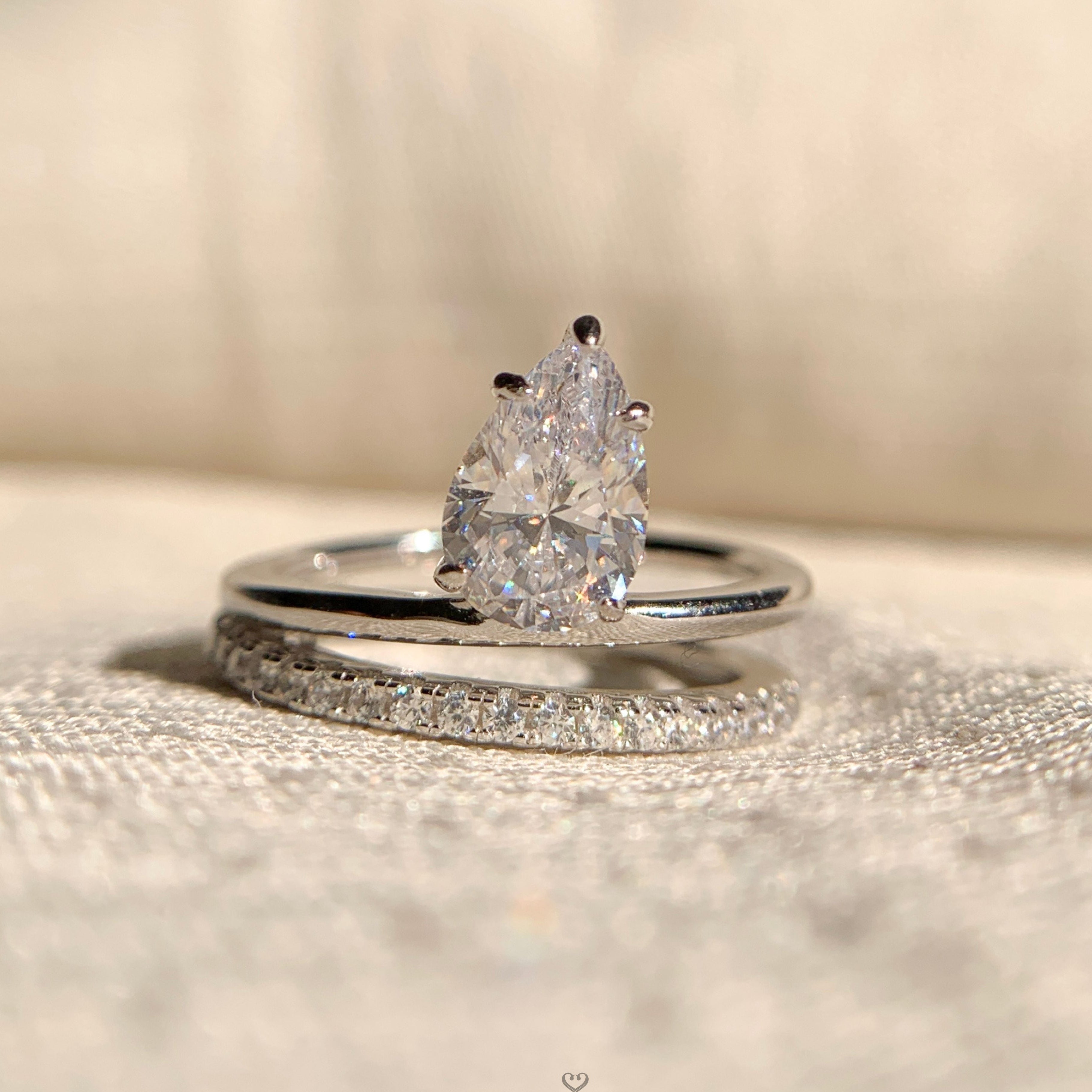 "Pear shape double band solitaire engagement ring in white gold"